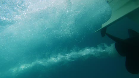slow-motion-close-up-of-boat-propeller-spinning-underwater-producing-air-bubbles-wake-from-engine