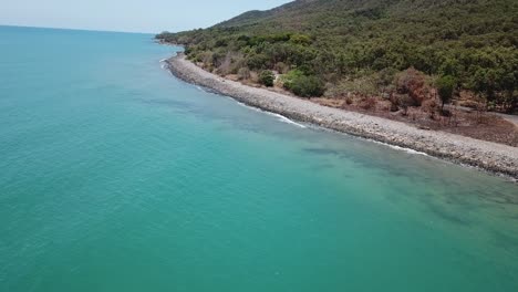 Drone-aerial-parallax-tropical-mountain-with-blue-water-beach
