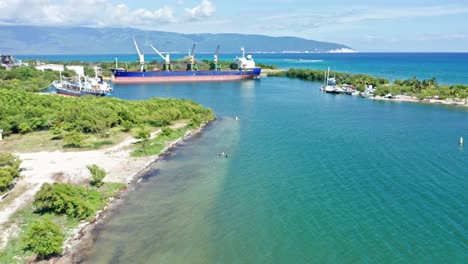 Aerial-view-of-Port-of-BARAHONA-with-docking-industrial-ships-during-sunny-day-on-Dominican-Republic