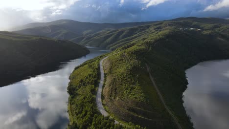 Aerial-view-of-Zêzere-river-valley-and-a-road-path-through-the-mountain