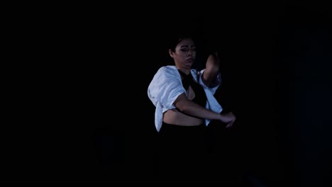 Young-Latina-Woman-Dancing-Whacking-in-Painful-Emotional-Release-in-Dramatic-Black-Background