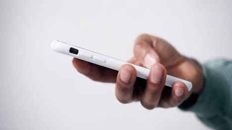 Close-up-of-African-American-hand-scrolling-on-a-phone-seen-from-the-side-on-a-white-background