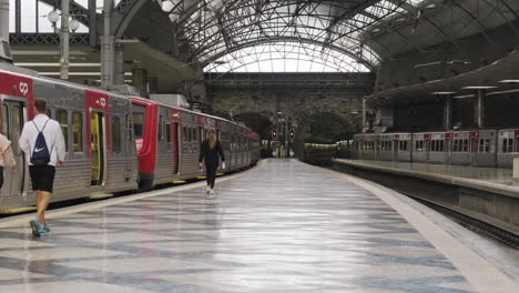 Passengers-Walking-On-Platform-While-Looking-At-Train-At-Rossio-Railway-Station-During-Novel-COVID-19-Pandemic-In-Lisbon,-Portugal