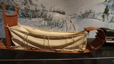 Panning-Shot-of-Wooden-Sleigh-Used-to-Transport-Goods-on-Display-at-the-National-Museum-of-Scotland