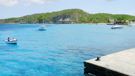 Small-local-fishing-boat-docking-at-a-jetty-in-the-beautiful-blue-bay-of-Boka-Sami-on-the-Caribbean-island-of-Curacao