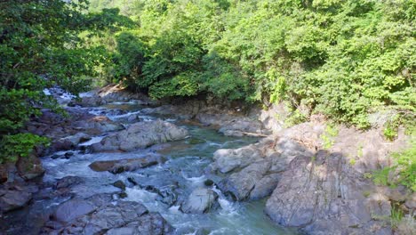 Water-Higuero-stream-flowing-between-rocks-in-untouched-nature,-La-Cuaba