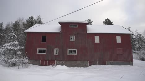 Snowy-Rural-Scene-With-Red-Cabin---tilt-up-shot