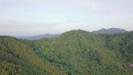Aerial-panoramic-shot-showing-picturesque-greened-mountain-range-early-in-the-morning