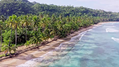Idyllic-island-scene-with-azure-water-and-palm-trees-on-sandy-beach