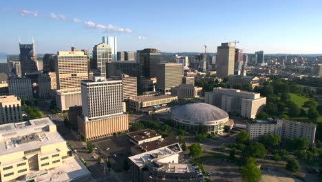 Aerial-view-away-from-the-Musicians-Hall-of-Fame-Museum-and-the-Nashville-skyline,-in-sunny-USA---pull-back,-drone-shot