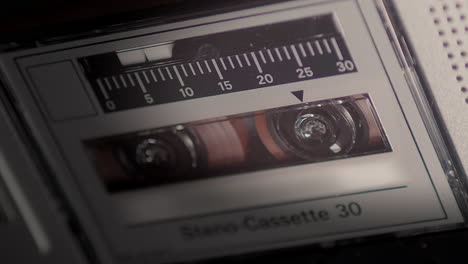 Primer-Plano-Del-Microcassette-Y-La-Cinta-Rodante-En-La-Grabadora