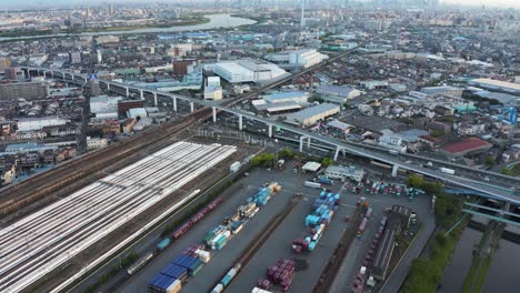 Japanese-Shinkansen-Trains,-Aerial-View-revealing-Osaka-in-distance