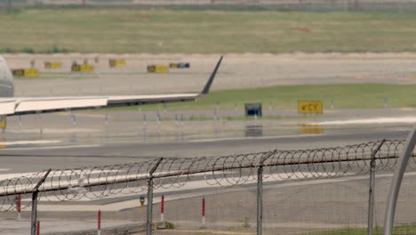 Plane-Passing-Barbed-Wire-Fence-On-Runway-Before-Taking-Off