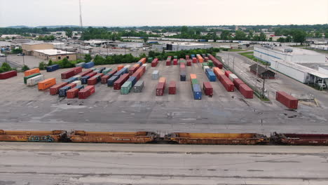 An-orbiting-aerial-establishing-shot-of-empty-cargo-train-yard-in-Jefferson-County,-Kentucky