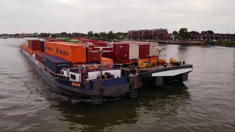 Aerial-Close-Up-View-Off-Forward-Bow-Of-Maas-Inland-Push-Tow-Cargo-Barge-Along-River-Noord