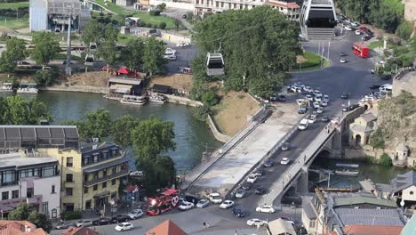 A-view-of-traffic-and-aerial-tram-at-city-centre-in-Tbilisi,-Georgia