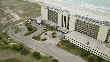 Shell-Island-beachfront-resort-aerial-tracking-into-entrance