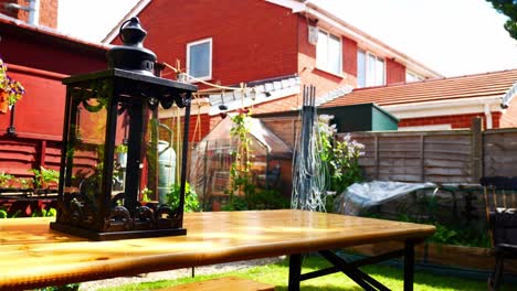 Ornamental-gothic-black-metallic-lantern-on-home-garden-table-furniture