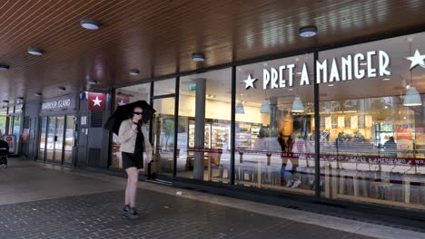 Isle-of-Dogs-London-England-September-2022-Exterior-panning-establishing-shot-of-Pret-A-Manger-next-to-South-Quay-station