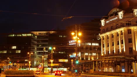 Day-To-Night-Time-Lapse-Of-Kalvin-Square-Budapest,-With-Modern-Office-And-Old-Building,-Tram-And-Vehicle-Traffic,-2022,-September