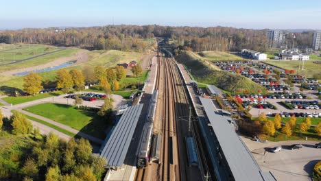 Aerial-view-of-train-station-with-one-train-arriving-and-one-departing