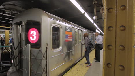 People-Enter-And-Exit-A-Subway-Train-In-New-York-City,-From-Platform-With-Pan