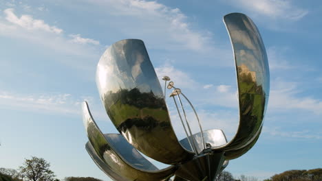 Airplane-passing-behind-Floralis-Generica-steel-sculpture-in-Recoleta-neighborhood-at-daytime-tight-shot