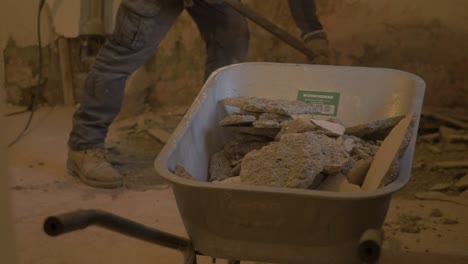 Shoveling-rubble-into-wheelbarrow