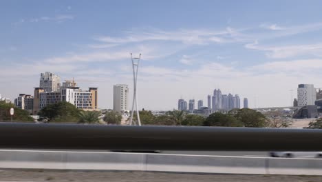 Driving-on-a-street-next-to-a-huge-skyline-of-dubai