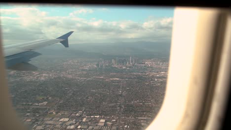 1080-slow-motion-POV-perspective-from-an-airplane-flying-into-LAX-and-passing-the-downtown-skyline