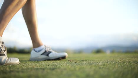 Slow-Motion-shot-of-a-golfer-chipping-a-golf-ball-using-a-pitching-wedge