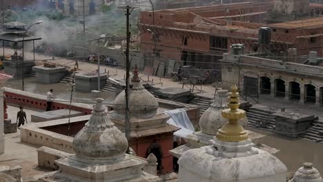 Slow-Motion-Pan-of-Pashupatinath-Temple-with-Open-Cremation-Ceremonies,-Kathmandu,-Nepal