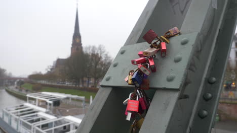 Multiple-love-locks-hanging-in-chains-from-a-bridge-in-Frankfurt