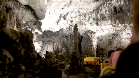 Postojna-caves-interior-pan-over-stalagmites-stalactites