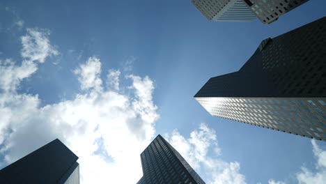 Singapore---Circa-Singapore-Skyscrapers-Towers-Timelapse-With-Blue-Sky-and-Small-Clouds