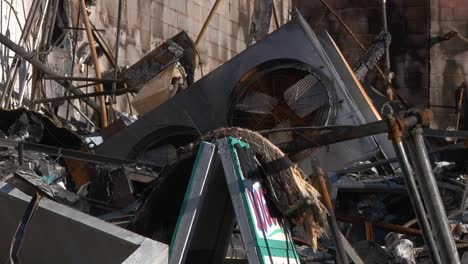 Camp-Fire-Destruction-Fan-Blowing-Breeze-Close-Up-Among-Devestation