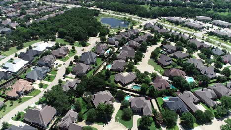 Aerial-video-of-Highland-Oak-subdivision-in-Highland-Village-Texas-with-houses-and-pond