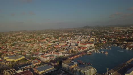 Aerial-pan-view-of-the-beautiful-marina-and-busy-streets-in-the-city-Oranjestad-of-Aruba-4K