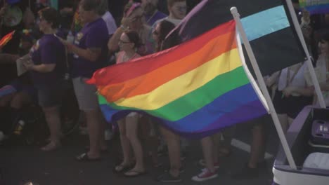 Slow-Motion-Shot-of-Pride-Flag-Waving-From-Back-of-Truck-at-River-City-Pride-Parade-in-Jacksonville,-FL