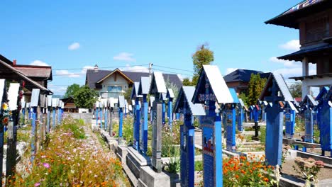 Panning-shot-of-the-coloured-tombs-and-church-at-the-"merry-cemetery"-of-Sapanta