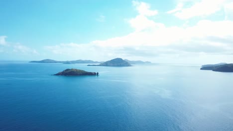 Drone-fly-over-a-family-looking-at-a-couple-of-islands-in-the-distance-surrounded-by-water-in-the-Comoros