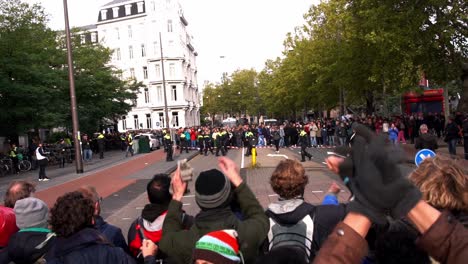 Young-people-participate-in-extinction-rebellion-climate-protest-in-Amsterdam-with-police-standoff-blockade,-XR-Amsterdam