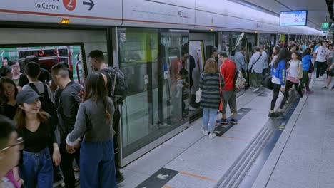 Pedestrians-board-and-alight-from-a-MTR-or-Mass-Transit-Railway-train