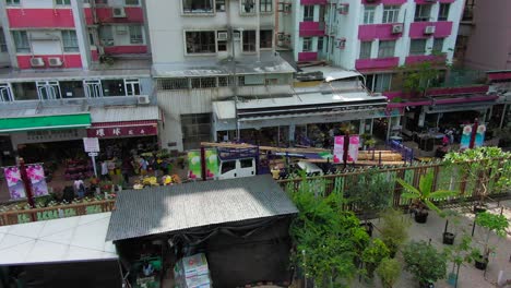 Hong-Kong-Mong-Kok-flower-market,-Pan-left-aerial-view-of-Flower-shops-and-surrounding-buildings