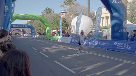 Crow-cheering-for-marathon-runner-finishing-the-last-meters-of-race---slow-motion