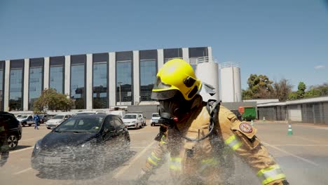 Feuerwehrmann-Wird-Mit-Einem-Feuerwehrschlauch-Besprüht,-Um-Schutzausrüstung-Zu-Reinigen,-Nachdem-Er-Auf-Einen-Brand-In-Einem-Covid-19-Krankenhaus-Reagiert-Hat