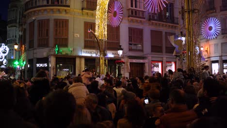 Big-crowd-watching-Christmas-light-show-on-Larios-street,-Malaga,-Spain