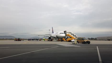 Luggage-is-taken-to-Lufthansa-airplane-on-tarmac-in-preparation-to-fly