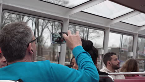 Medium-close-up-shot-of-people-on-a-canal-cruise,-in-Amsterdam