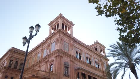 Reveal-of-Historic-Building-in-Downtown-Seville,-Spain-on-Sunny-Day